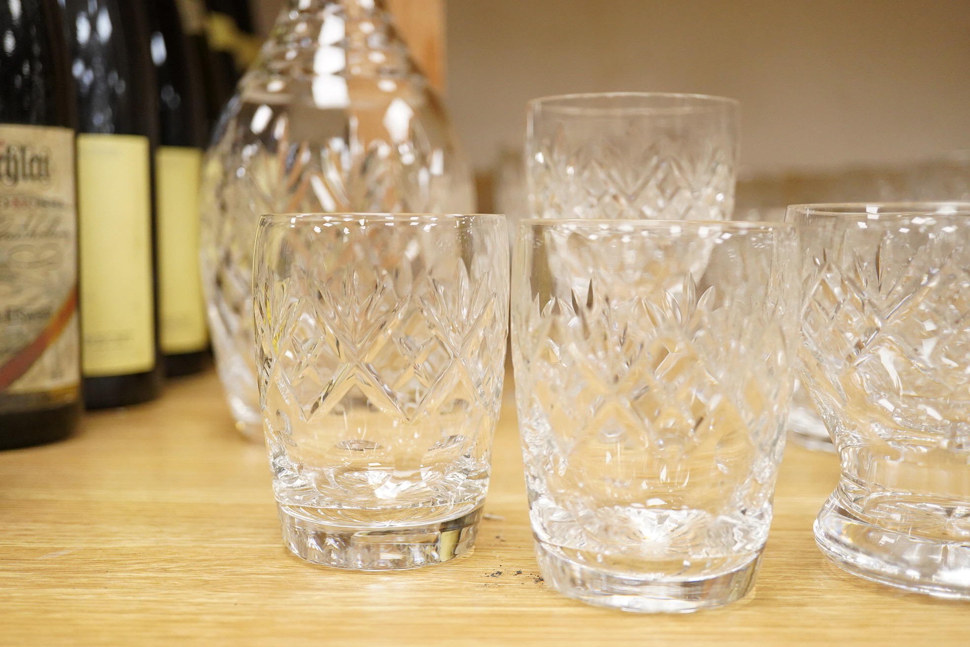 A collection of Webb cut glass suites and four decanters, together with a glass jug, largest 35cm high